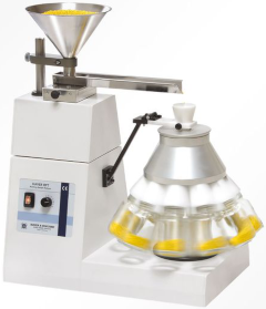 Photograph of a Haver & Böcker spinning riffler (rotating sample divider) with ten receiving containers. KTH Powder Characterisation Laboratory has an identical machine.