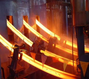 Steel "strands" being continuously cast. The glowing samples are solid on the outside and molten on the inside.